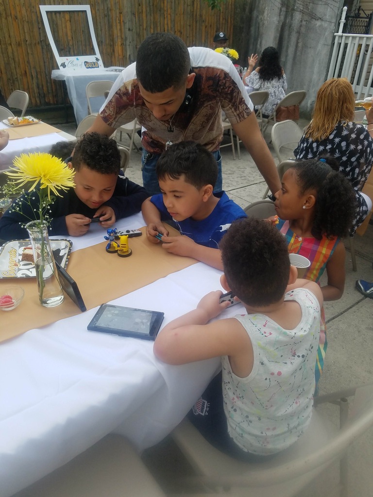 Young Konnor helping kids at a party